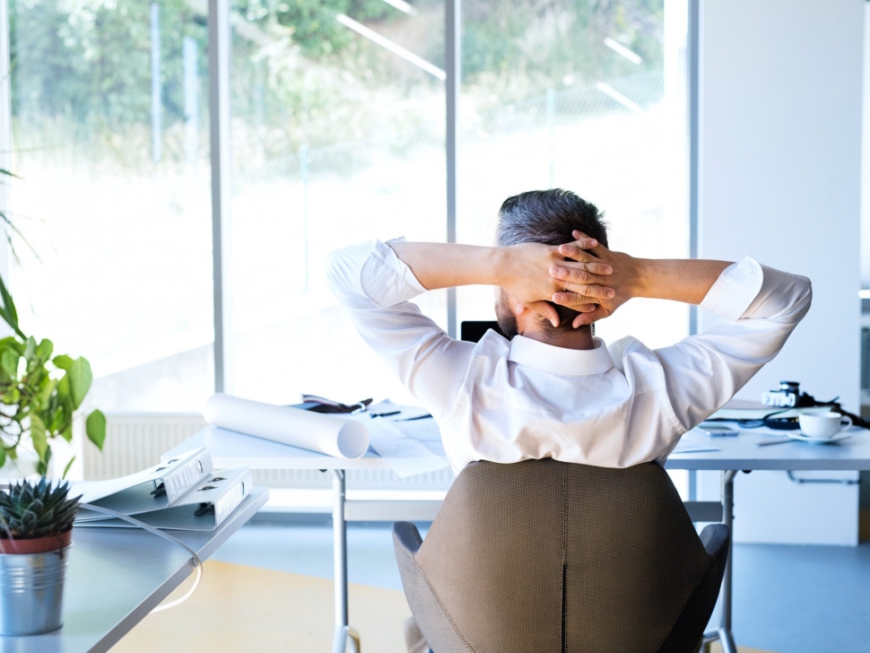Businessman at the desk in his office resting.